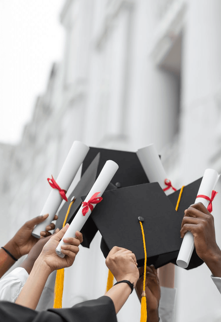 Graduates holding caps and diplomas